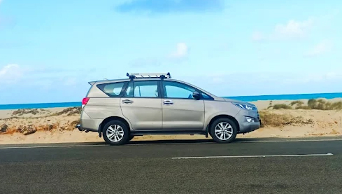 SUV parked near beach highway under clear sky – Tour operator Madurai with tour package